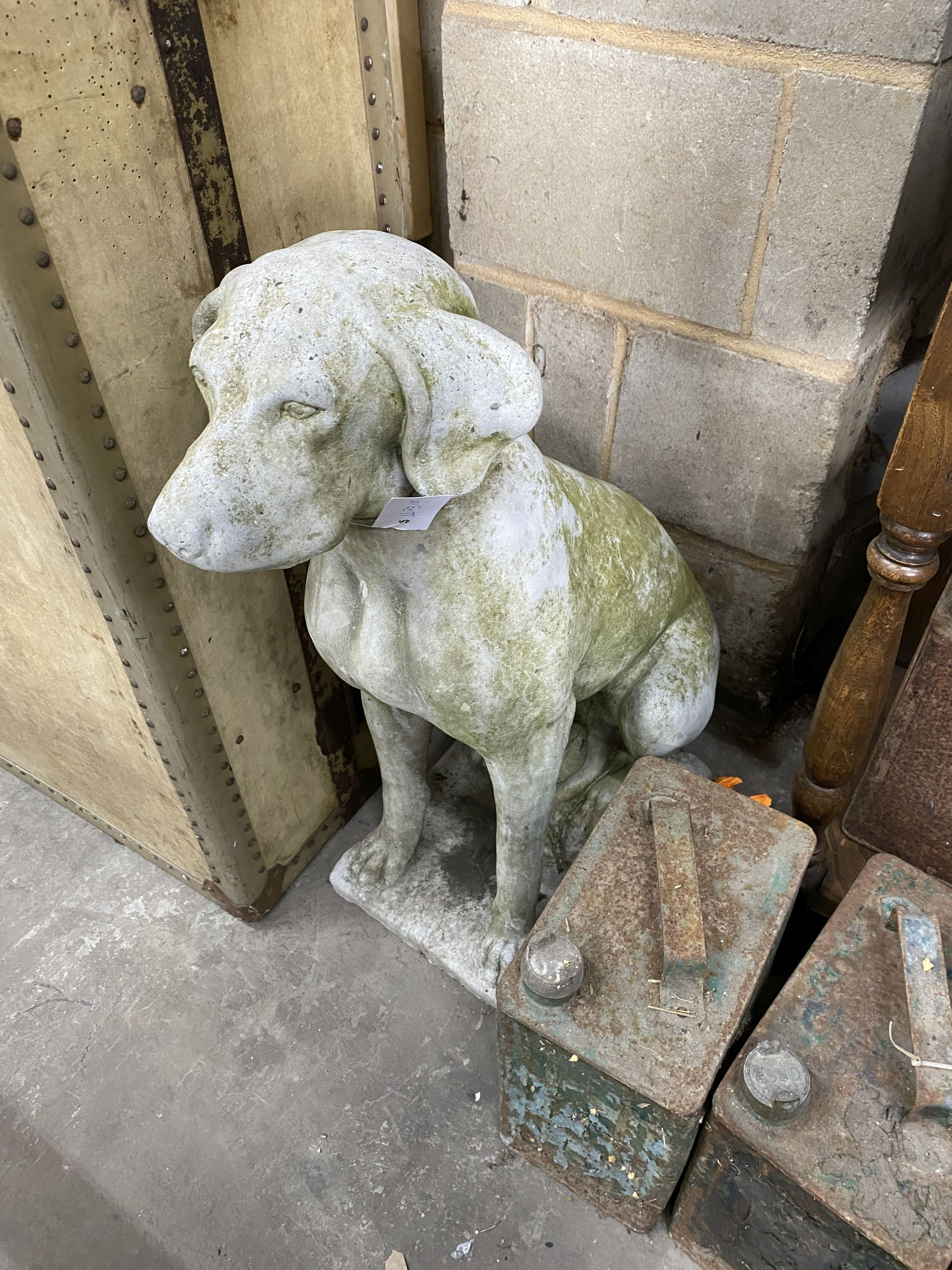 A pair of reconstituted stone seated hound garden ornaments, height 70cm